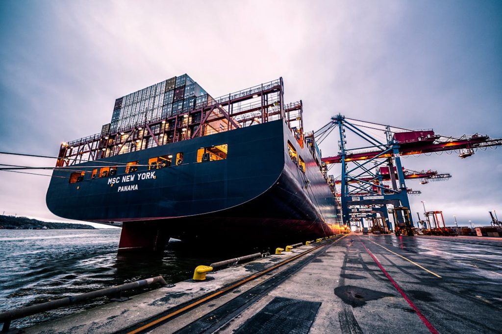 A large cargo ship docked at Gothenburg port with industrial cranes, Sweden.