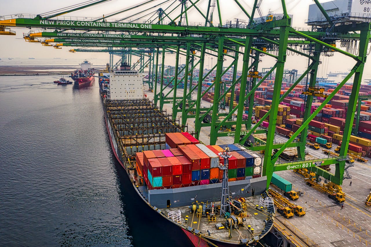 Container ship loading at New Priok Container Terminal in North Jakarta, showcasing the bustling industrial port.