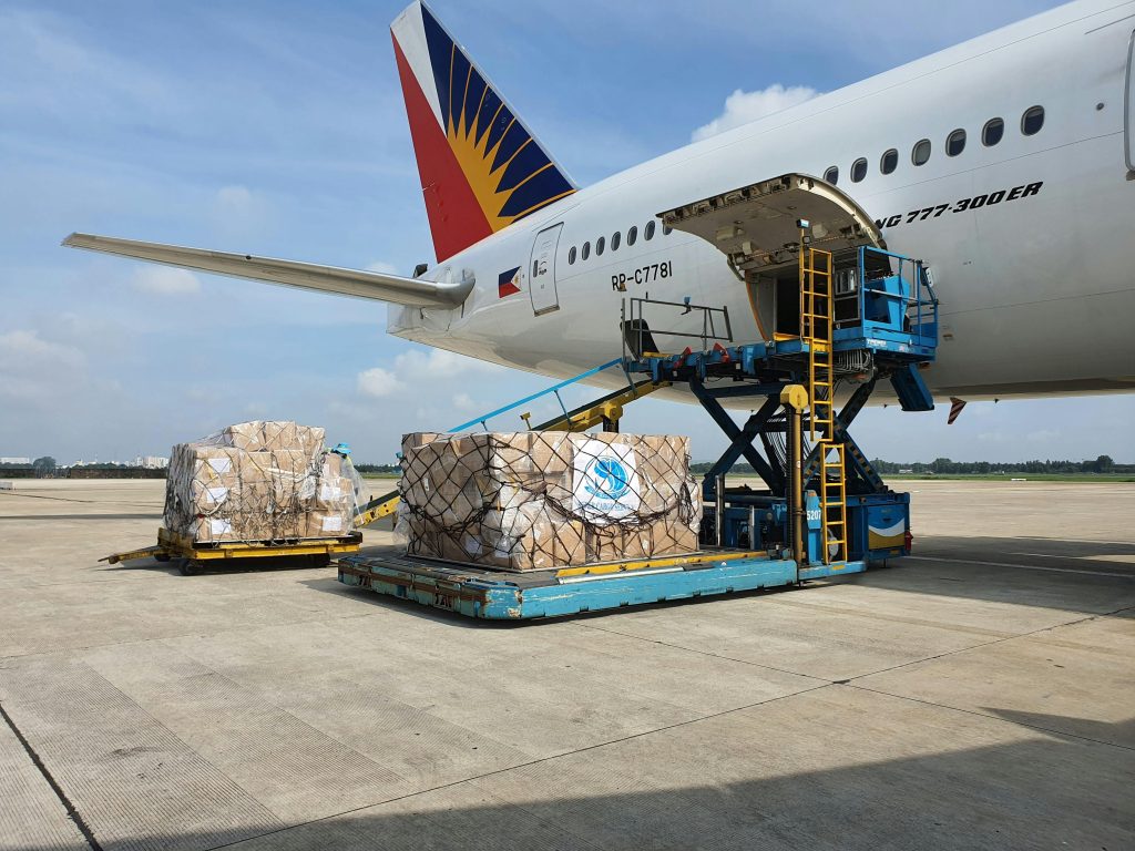 Cargo being loaded onto a commercial airplane at an airport in Ho Chi Minh City, Vietnam.